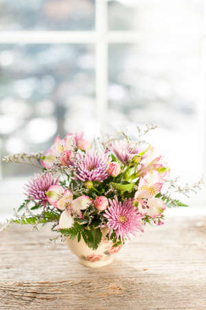 Bouquet of colorful flowers arranged in small vaseの写真素材