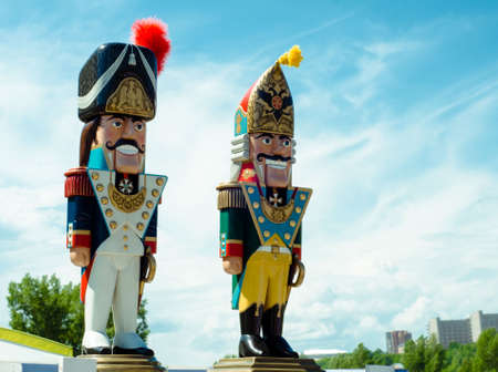 Toy Nutcrackers in the form of guards in bright uniforms against the blue sky. Military figures in historical costumes. Russia. Krasnoyarsk June 19, 2016のeditorial素材