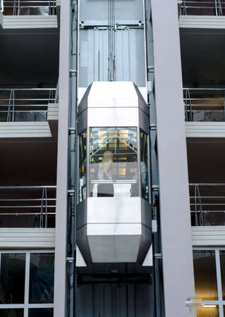 Modern high-speed metal and glass passenger elevator in an office building.の写真素材