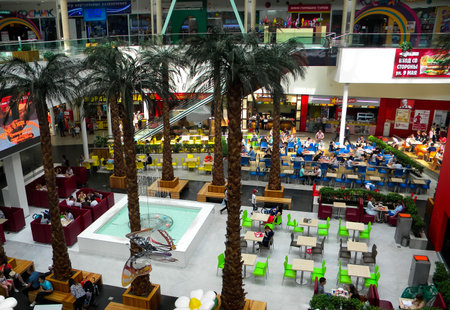 cafe in large shopping center, dominated by palm trees. Food-court. Numerous tables in bistro. Russia. Krasnoyarsk. December 31, 2008のeditorial素材