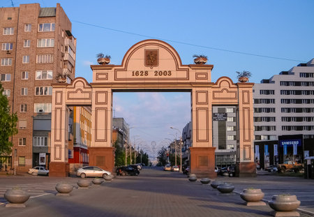 Triumphal arch in city of Krasnoyarsk. Empty streets of modern city. Tall buildings and shopping centers against blue sky. Krasnoyarsk. Russia. June 10, 2015のeditorial素材
