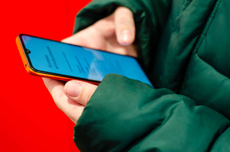 mobile phone in hands of person. Modern means of communication.のeditorial素材