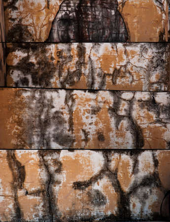 Worn, rust and weathered paint on textured cement. の写真素材