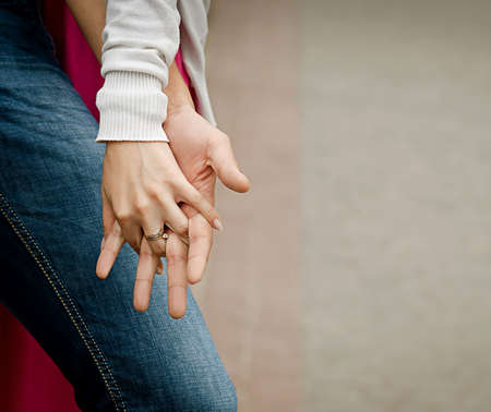 A young couple holding hands, outdoorsの写真素材