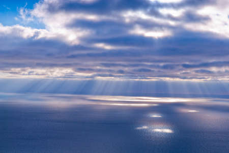 Beautiful scenery with clouds and sunbeams in blue and pink colorsの写真素材