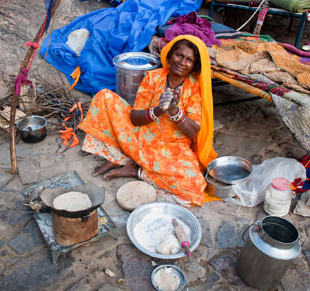 JAIPUR, INDIA-SEPT 26 : Indian woman preparing a meal on the street, on the way to Surya Mandir or...
