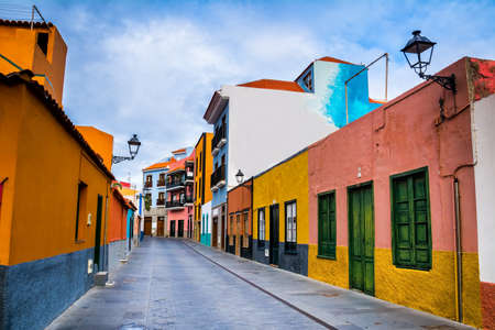 Colourful houses on street in Puerto de la Cruz town, Tenerife, Canary Islands, Spain. This is tourist pedestrian street near the ocean there are many restaurants and storesの写真素材