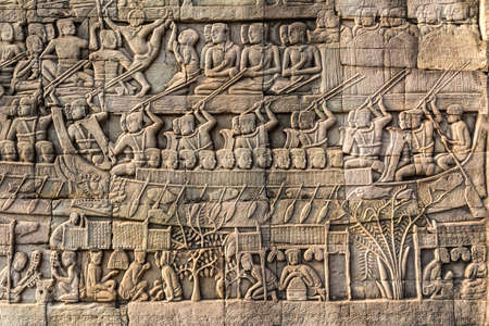 Bas-relief Sculpture at Bayon temple in Angkor Thom, Siemreap, Cambodia. Angkor Thom is a popular tourist attraction.の写真素材