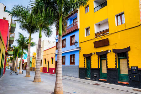 Tenerife. Colourful houses and palm trees on street in Puerto de la Cruz town, Tenerife, Canary Islands, Spainの写真素材