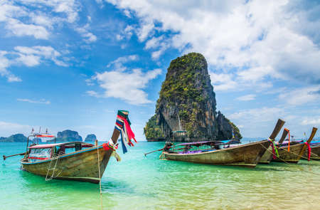 Amazing view of beautiful beach with longtale boats. Location: Railay beach, Krabi, Thailand,...