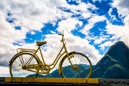 Vintage bicycle stands on a bridge, in the background of a mountains. Odda, Norway, Scandinaviaの写真素材