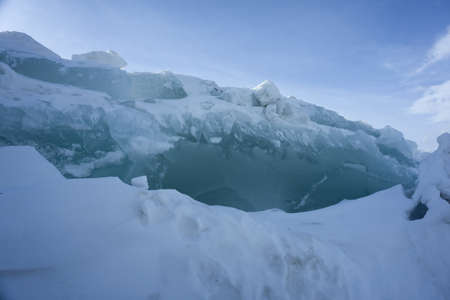 Ice hummocks on Lake Bolshoe Krasnoyarsk Krai Siberia Sunny day blue sky white snow azure ice.