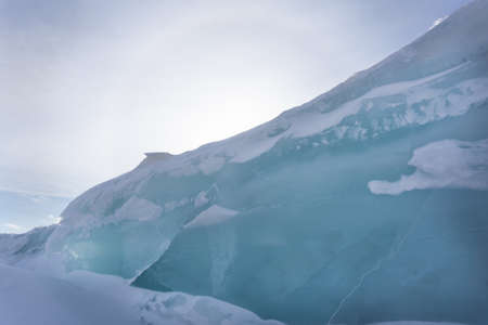 Ice hummocks on Lake Bolshoe Krasnoyarsk Krai Siberia Sunny day blue sky white snow azure ice.