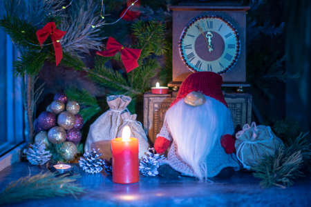 Decorated window for Christmas, spruce branches with red bows, Santa Claus with a bag of gifts,...
