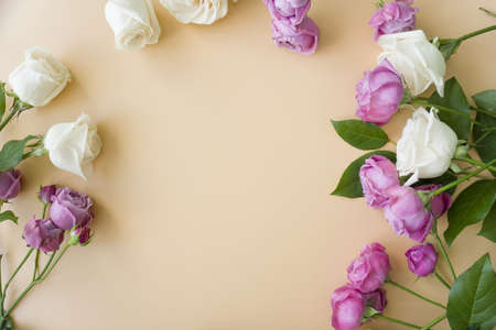 Background mock up greeting card, place for an inscription with a frame of flowers on a beige...