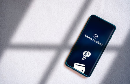 Top view of smartphone transferring money online on screen. Concept of financial transactions with...