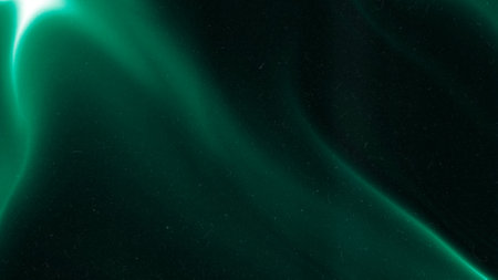 Green emerald color gradient grainy background. Illuminated spots on black. Noise texture effect.の写真素材