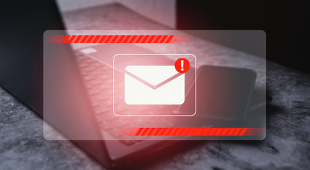 Inbox receiving electronic message alert. Smartphone laying on laptop with email virtual screen....