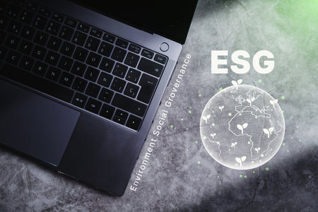 Laptop on desk with ESG icon green earth concept for Environment Society and Sustainable Governance of the world. Green business natural environment. Save planet.の写真素材