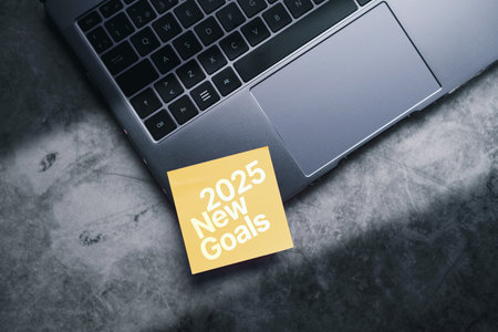 Business goals trends 2024. Adhesive note on laptop for 2025 new goals. Planning business growth 2025. Digital marketing strategy. Stock market trends and business.の写真素材