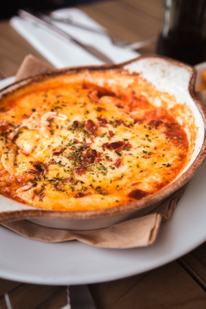 Delicious Italian provolone baked with tomato sauce and oregano.の写真素材