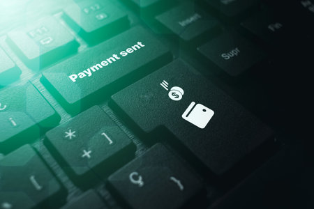 PC keyboard with Payment Sent button. Concept of financial transactions with mobile devices. Closeup...