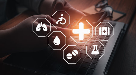 Woman use laptop with hologram interface of medical insurance. Family health care medical concept.の写真素材