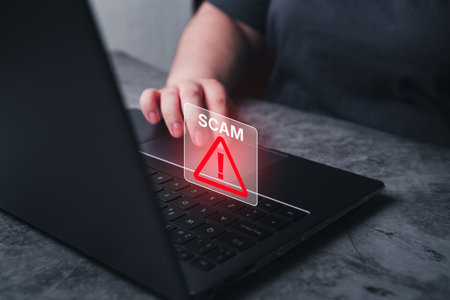 Fraudulent online concept. Woman receives alert scam notification on laptop. Security information...