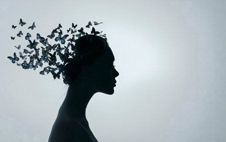 Silhouette of woman with colorful butterflies. The alzheimer dementia illness disease concept. Amnesia, memory loss and confusion.の素材