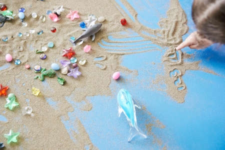 Children painting on sandの写真素材