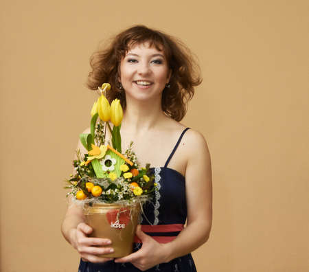 Smiling young woman with flowers. Fly.の写真素材