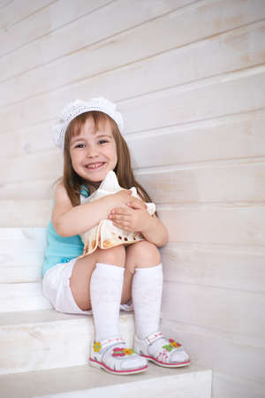 Young girl white seashell indoors.の写真素材