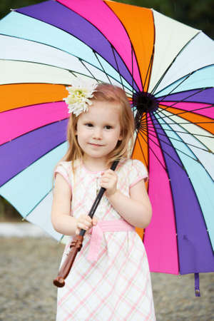 Little girl. Multicolored umbrellaの写真素材