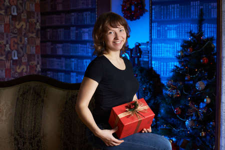 Girl with a gift. Christmas interiorの写真素材