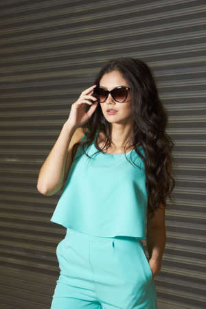 Girl. Blue suit. Sunglassesの写真素材