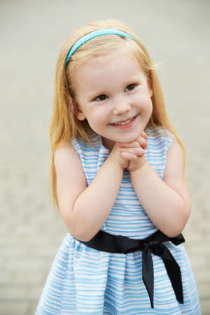 Portrait of a girl. Blonde in a blue dressの写真素材