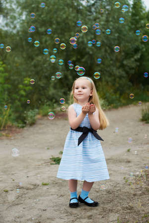 Girl in a blue dress. Bubbleの写真素材