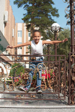 Playful child. Portrait girl. Background city. Walk park. Flight.の写真素材