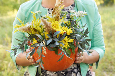 Pumpkin. Bouquet. Autumn flowers. Girl. Nature. Halloween.の写真素材
