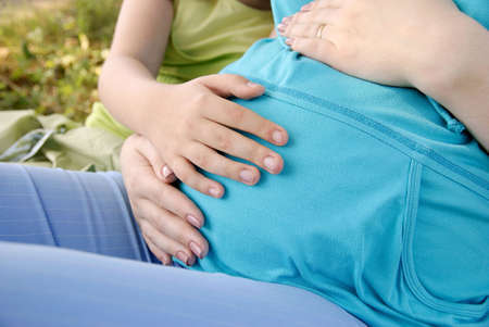 Pregnancy. Sister. Care. Stomach. Gentle touch. Expectation.の写真素材