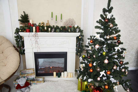 Christmas interior. The Christmas tree. Fireplace. Scenery. Decoration. Gift.の写真素材