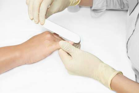 Nail treatment. Manicure. The fillet. Fingernails. White background.の写真素材