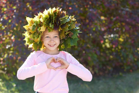 Autumn. Heart. Wreath. Portrait girl. Smile child.の写真素材