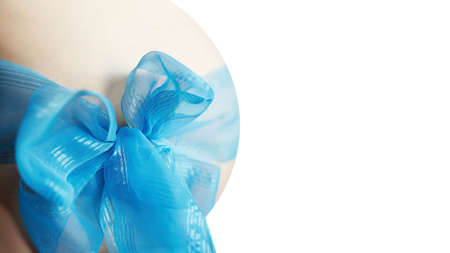 Pregnancy. Boy. Stomach. Blue bow. Expectation.の写真素材