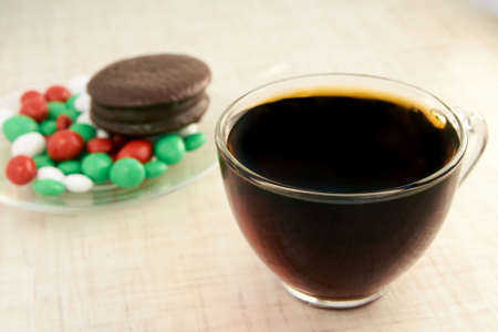 Multicolored candy. Black tea. Chocolate cake.の写真素材