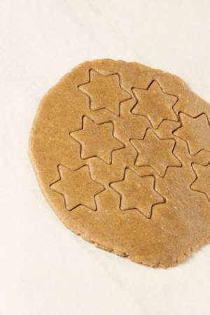 Gingerbread Cookie. Ready dough. Shape star. White background.の写真素材