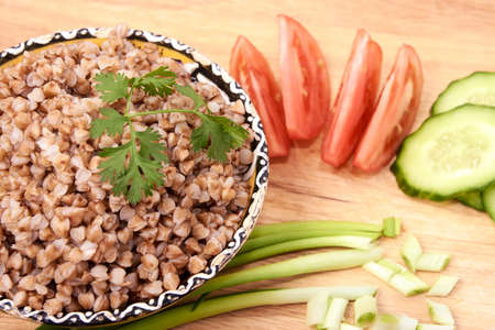 Proper nutrition. Buckwheat. Fresh vegetables. Brown background.の写真素材