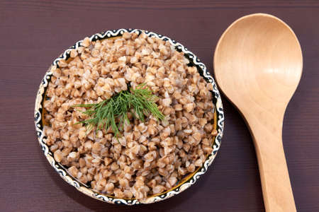 Cooked buckwheat. Healthy lunch. Brown background.の写真素材