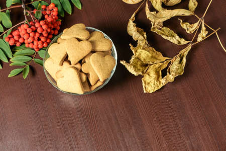 Heart cookie. Autumn still life. Rowan branch. Yellow leavesの写真素材
