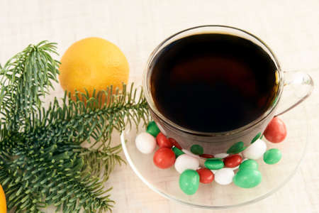 Branch eaten. Hot tea. Multicolored candy. Mandarin.の写真素材